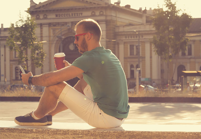 Man drinking beer while traveling
