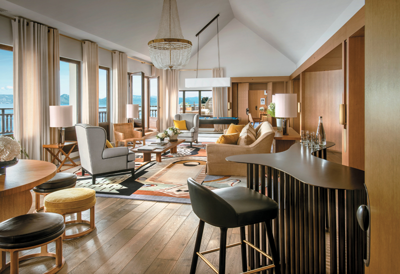 The Royal Suite has a large living room with a sitting area and a pool table dining table for six and a separate bar 