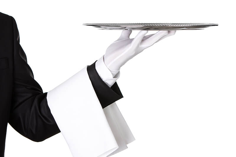 Waiter holding silver platter - NastcoiStockGetty Images PlusGetty Images