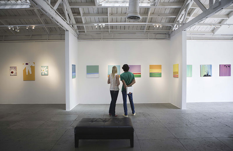 Two people looking at art in an art gallery