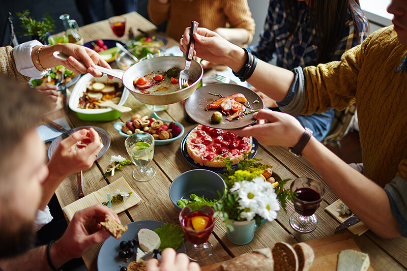 Dinner table with food and people eating