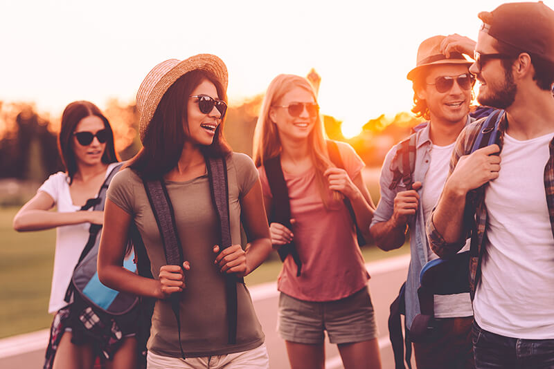 Group of young men and women traveling