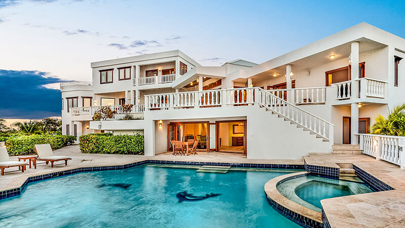 A villa with a pool in front of it by Sheriva Luxury Villas  Suites