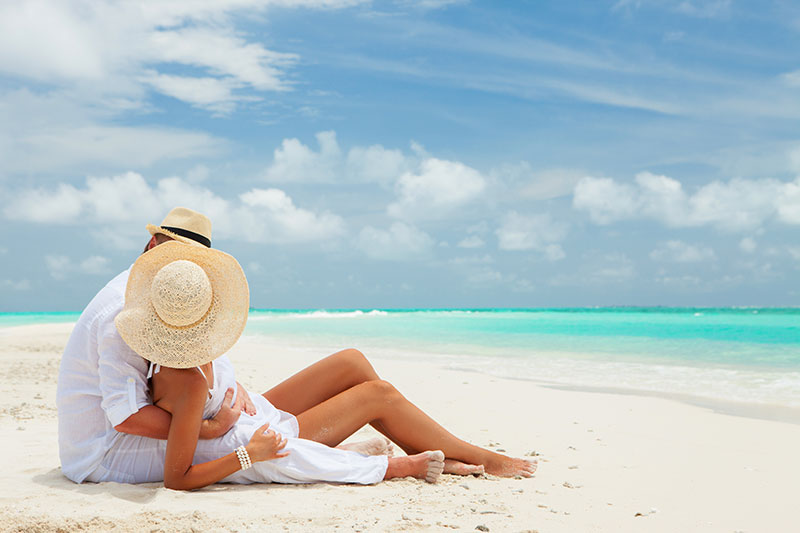 A couple lounging on the beach