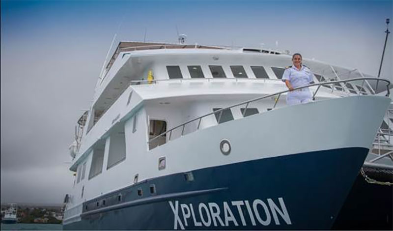 Nathaly Alban standing at the bow of Celebrity Xploration