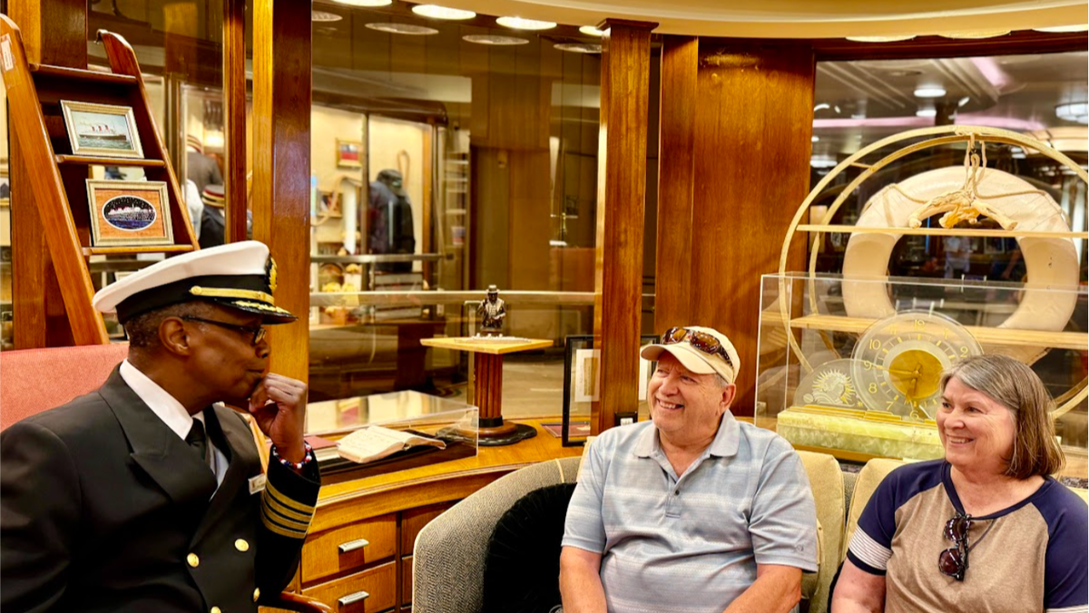 Captain James visits with guests in the Commodores Office onboard The Queen Mary