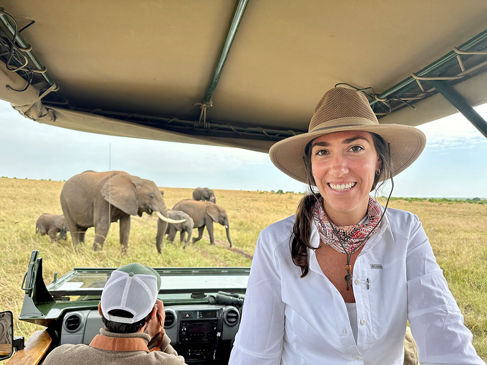 image of woman on safari with elephants behind her