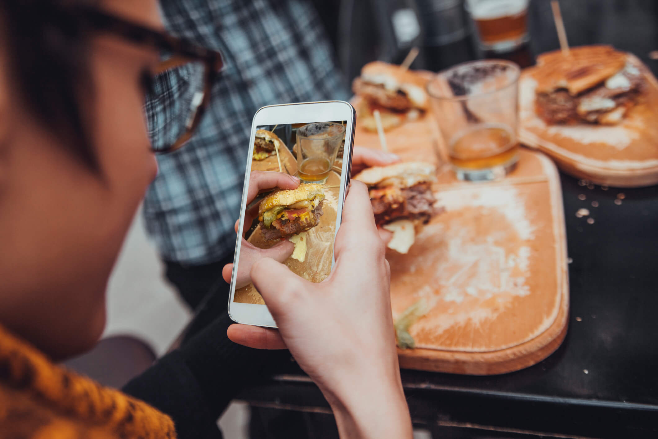 Gen Z snapping pic of food burgers and beer