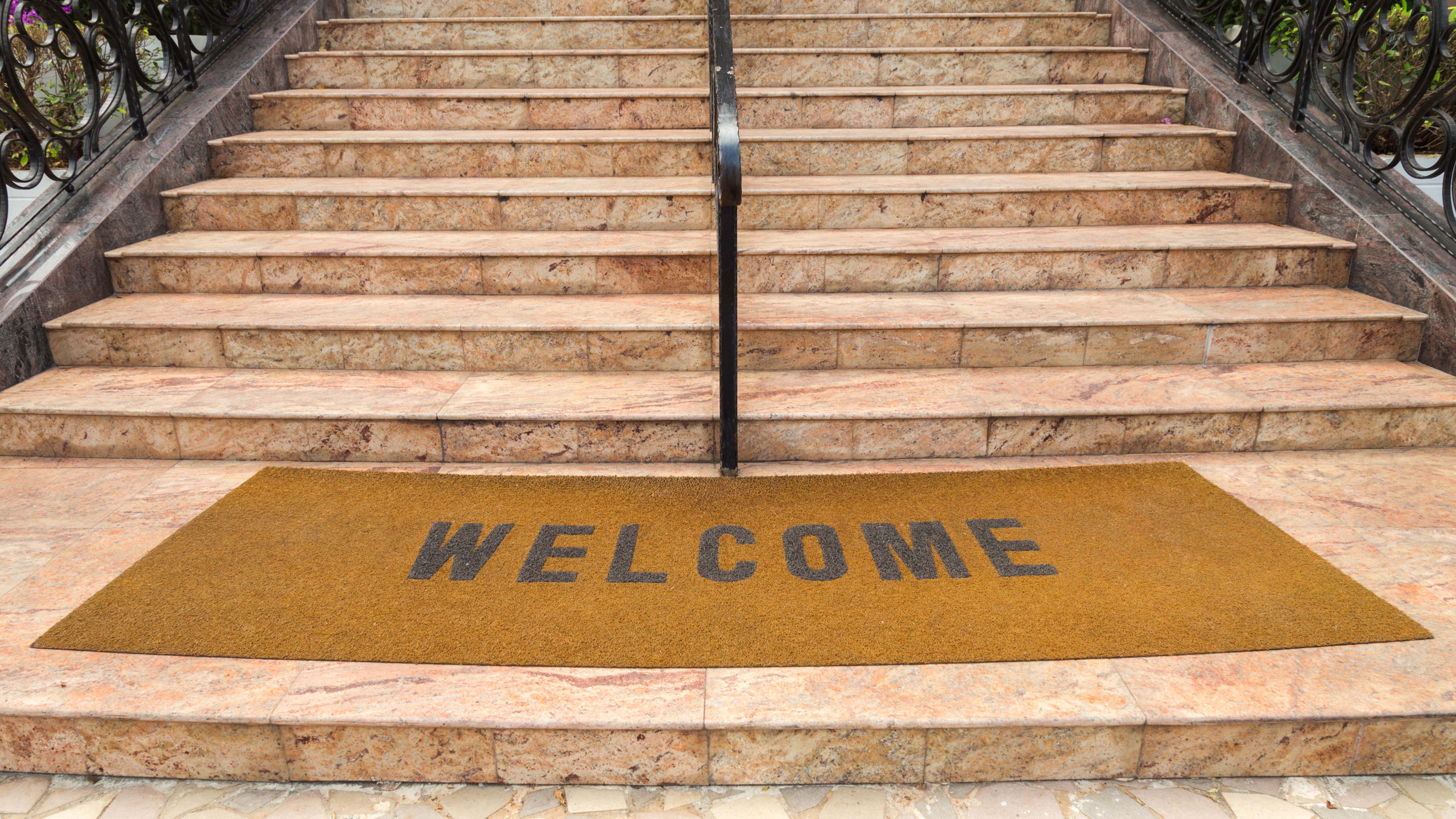 Welcome mat at bottom of stairs
