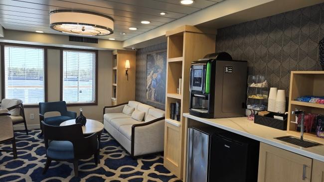 Guests will find comfortable seating area plus a grab-and-go bar for snacks and drinks at the Sky Lounge on American Serenade. During set hours, the lounge also has servers who will bring drinks from the bar.