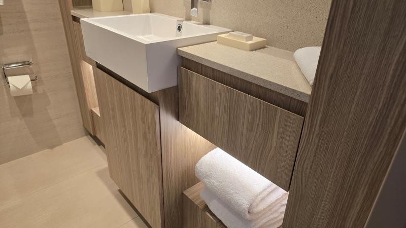 #210 has a single, elongated sink, but two people can get ready at the same time with counter space, a drawer and shelf space on both sides. 