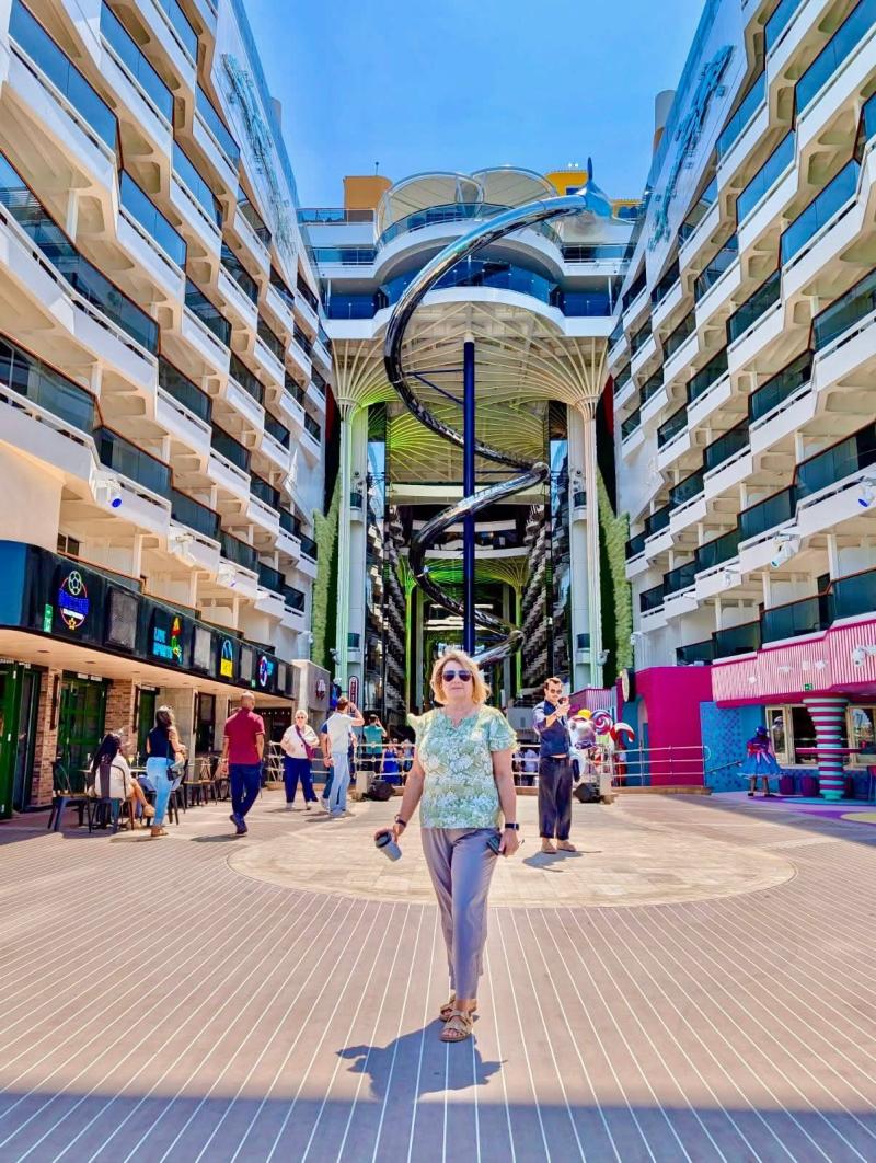 Standin within the World Promenade with the Jaw Drop slide in the background is helly Ricker, a franchisee of Expedia Cruises, from Saint John, New Brunswick, Canada.