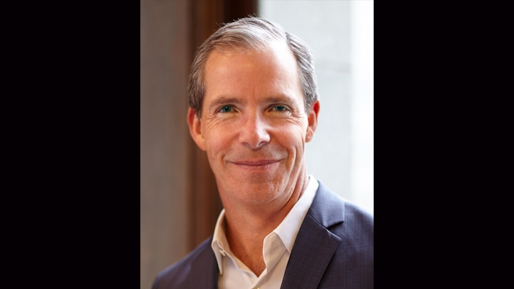 image of Greg Flynn in suit with brown hair