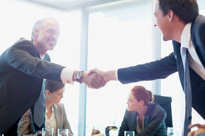 Business executives shaking hands
