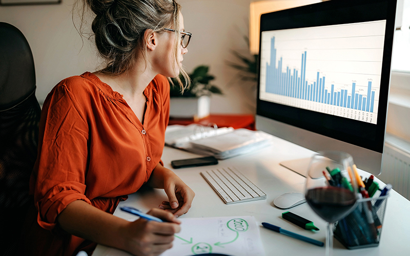 woman looking at data on computer