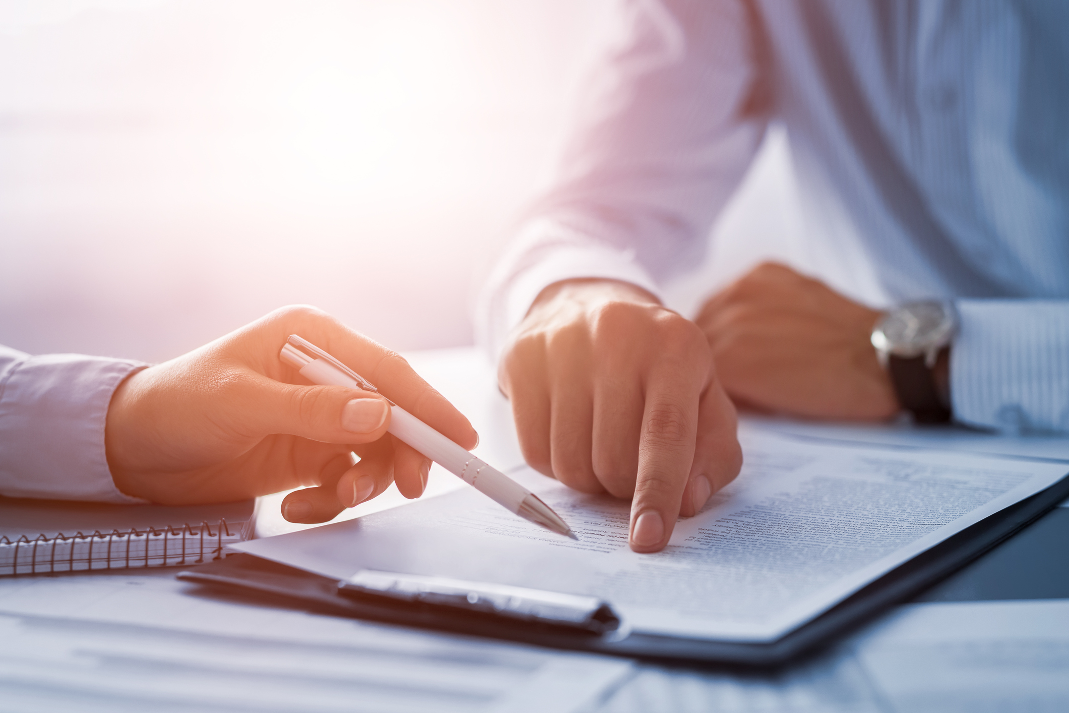 Human hands working with documents at desk and signing contrac