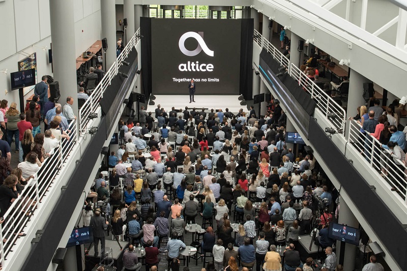 Altice USA logo amid crowd