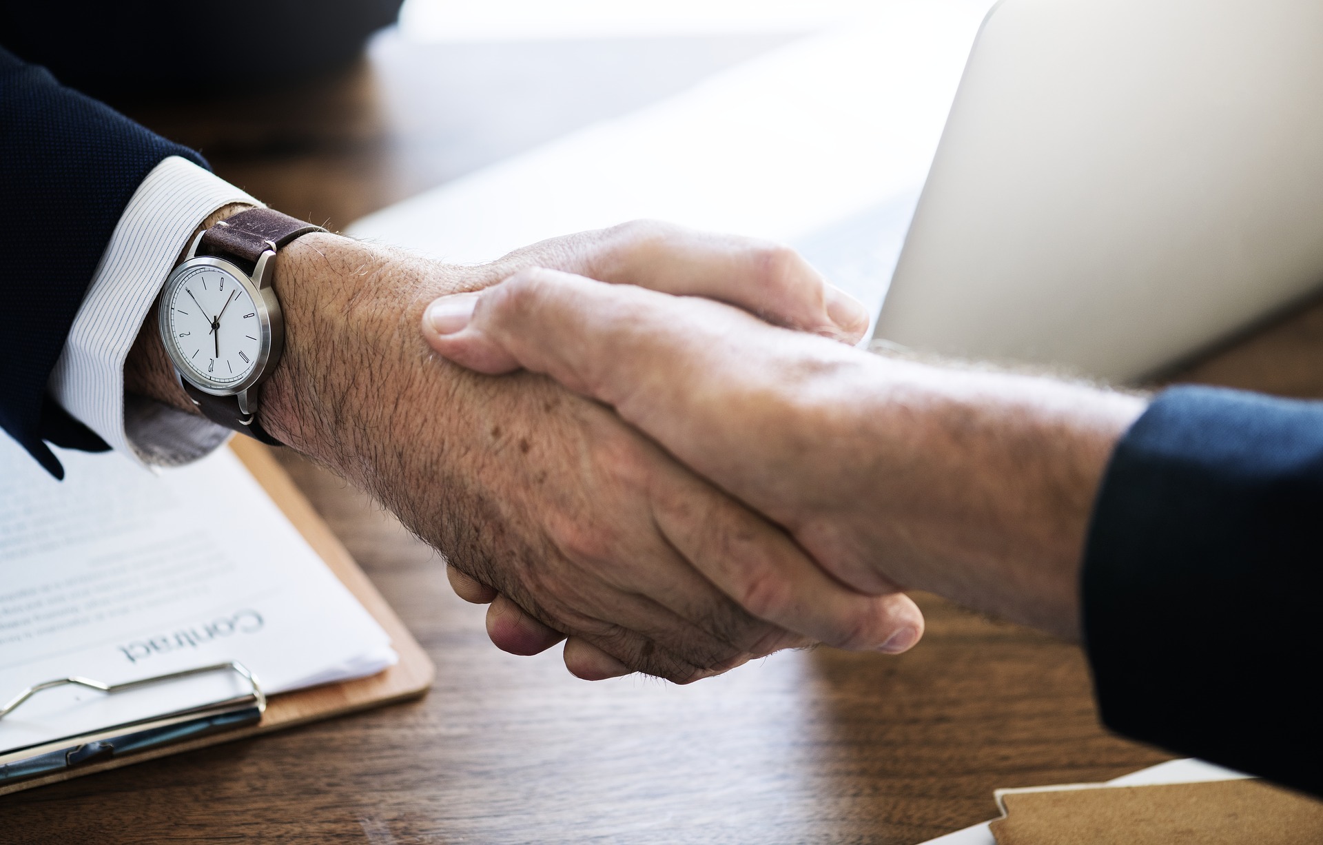 Handshake business deal executives