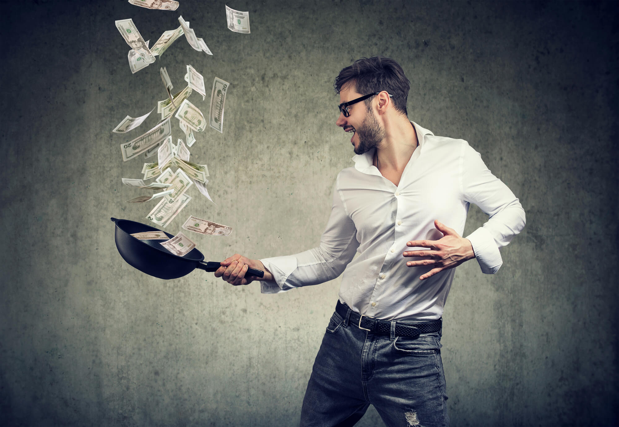 Man tossing money in a frying pan