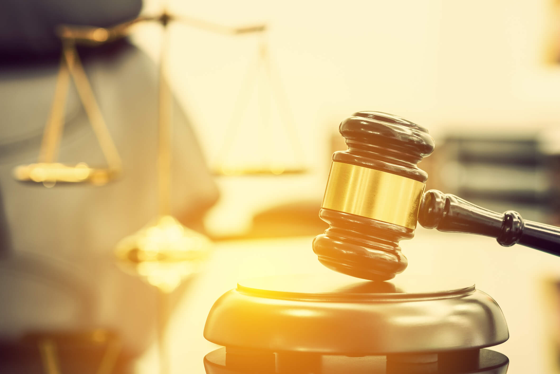 Gavel with scales of justice in background