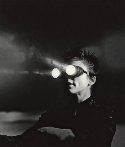 Laurie Anderson wearing flashlight goggles.