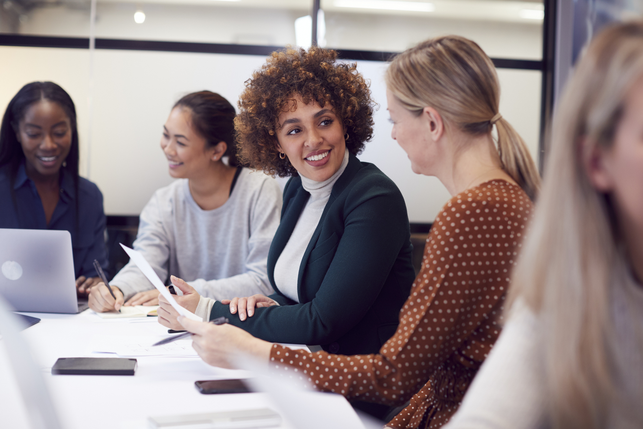 group of women executives collaborating during a meeting