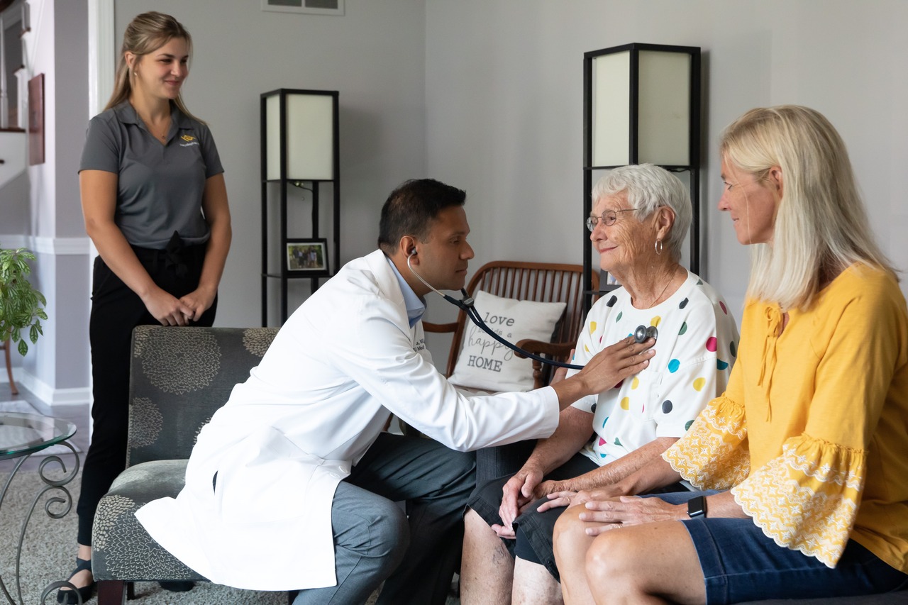 a physician treats a patient during a house call