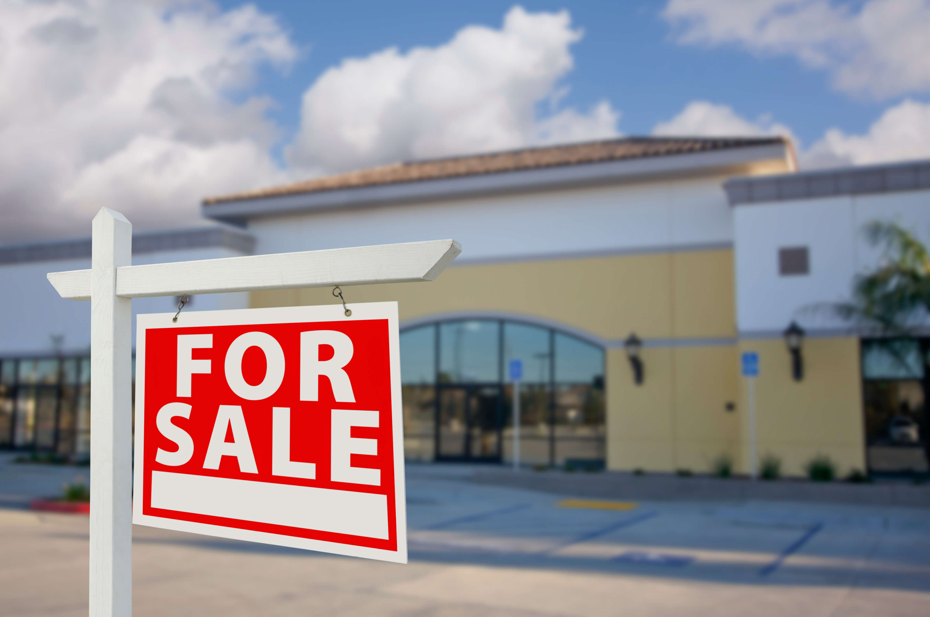 For sale sign in front of a business