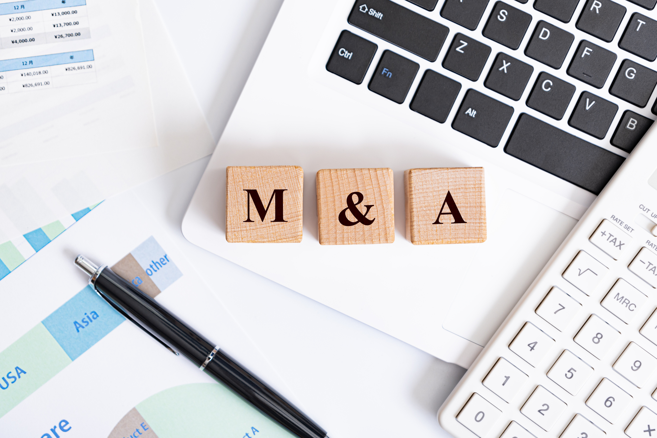 MA concept - MA word made with wooden blocks on laptop
