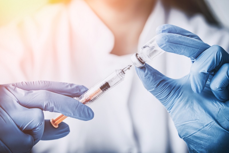 A nurse preparing a medical injection