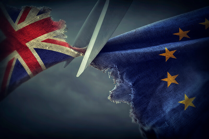 British flag being cut by scissors from the European union flag