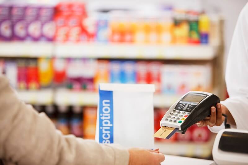 Woman paying for a prescription at a pharmacy