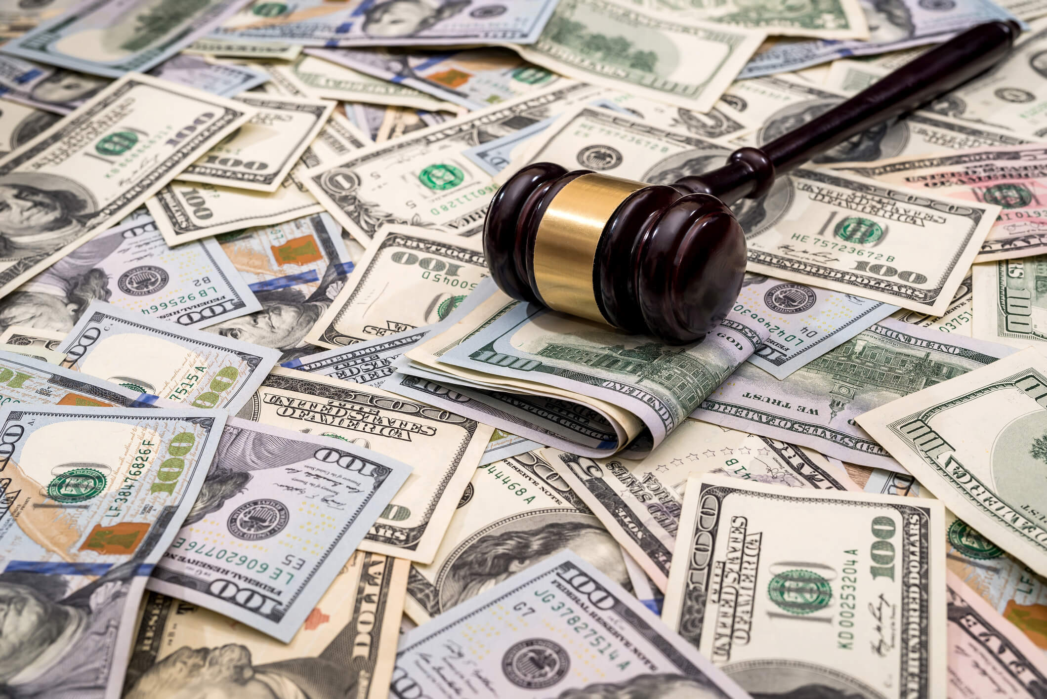 Gavel on top of cash